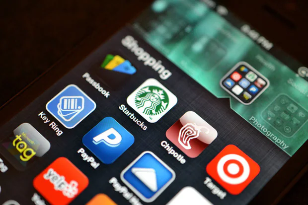 Smartphone displaying shopping, payment and loyalty app icons