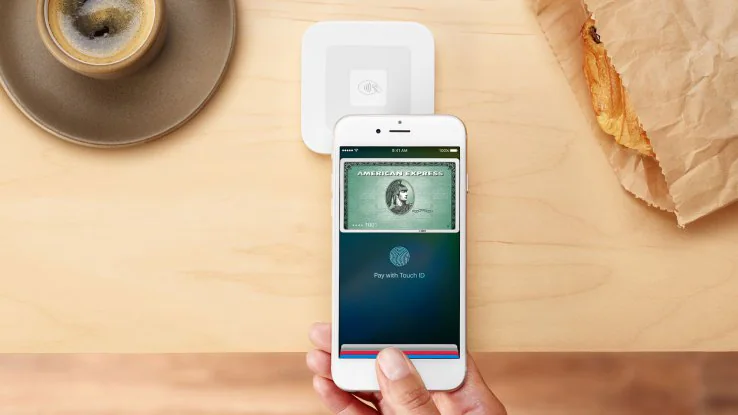 iPhone using Apple Pay beside a Square contactless reader