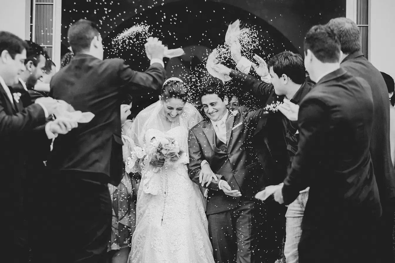 Newlywed couple celebrating under confetti