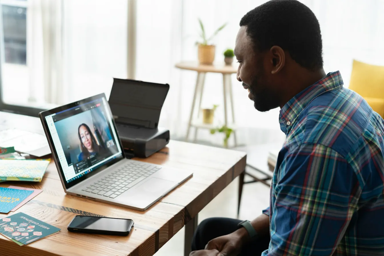 Professional taking part in a virtual meeting on a laptop