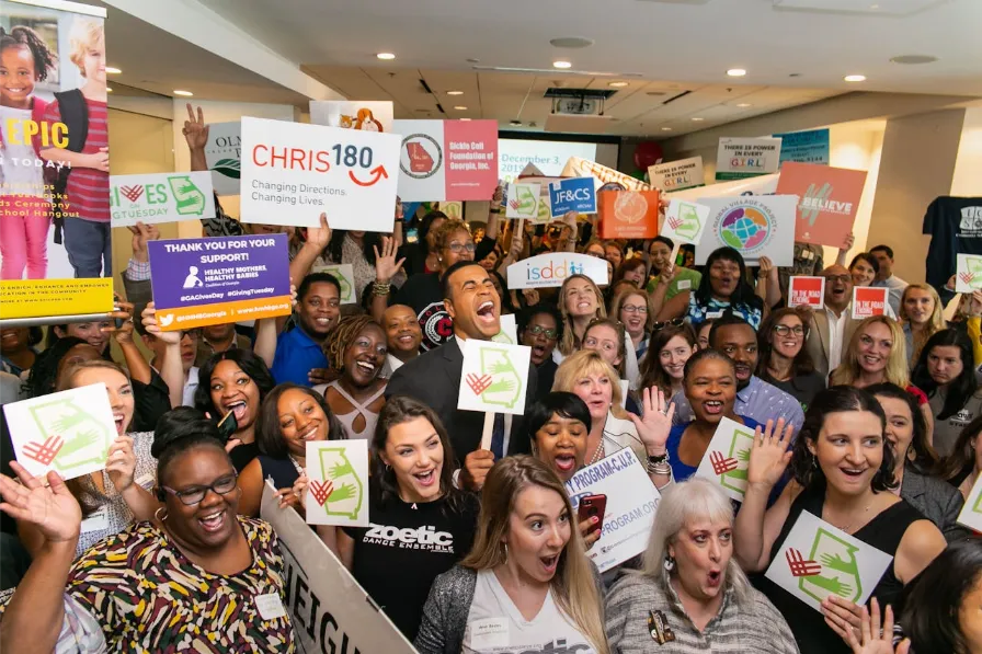 Charity volunteers cheering together with signs