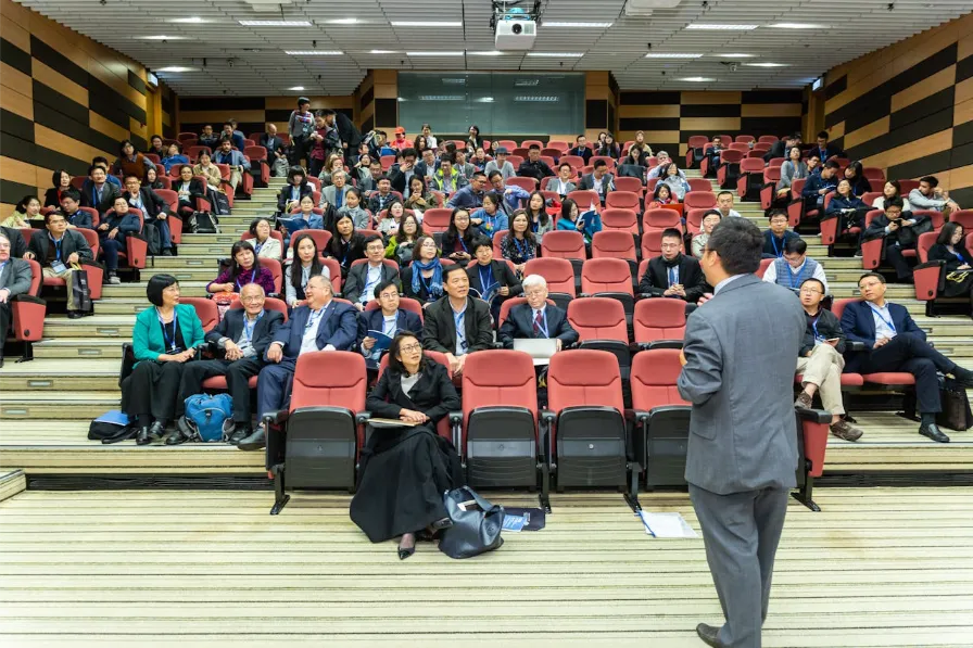 Speaker addressing an audience in a lecture hall