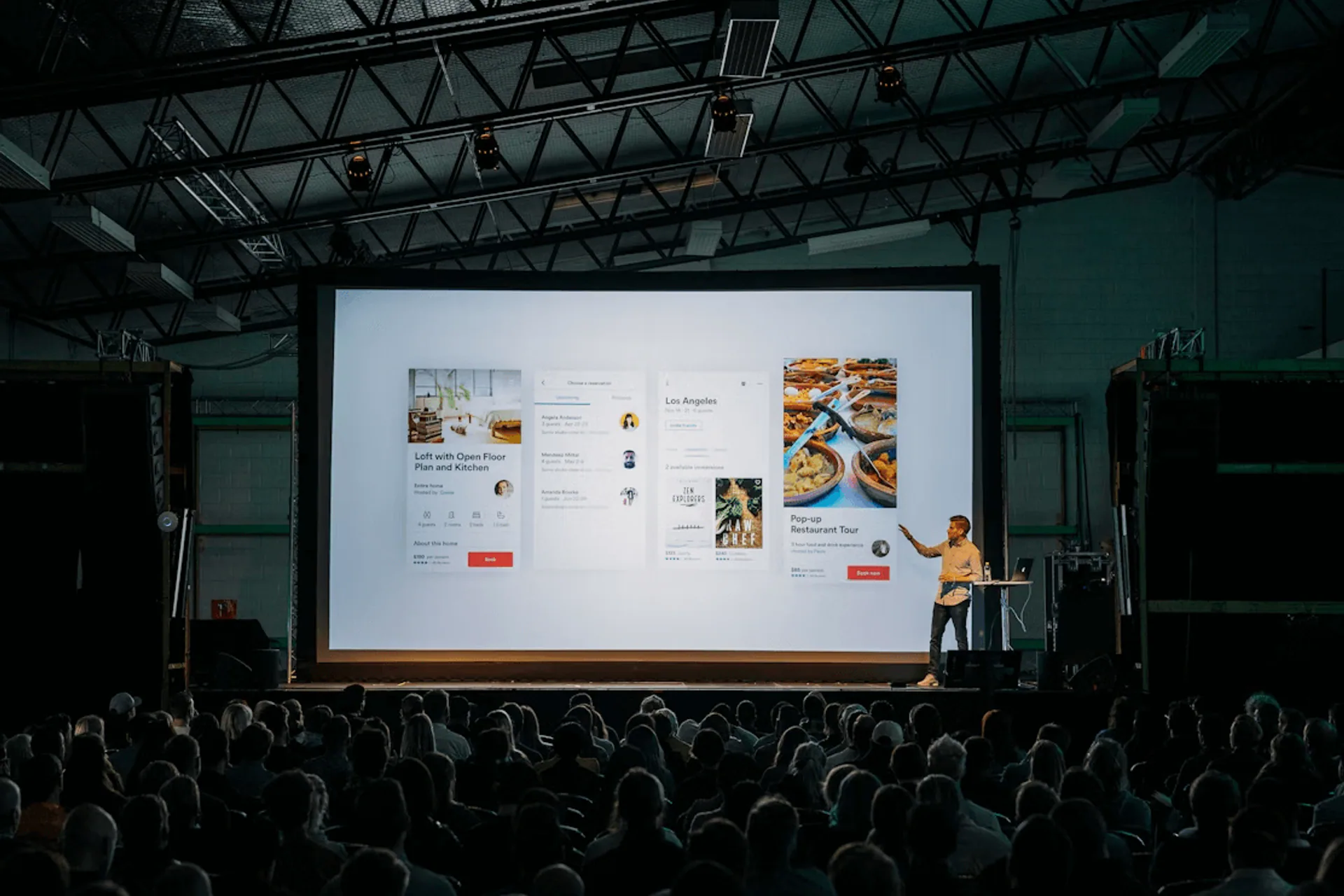 Presenter speaking to an audience at an event venue