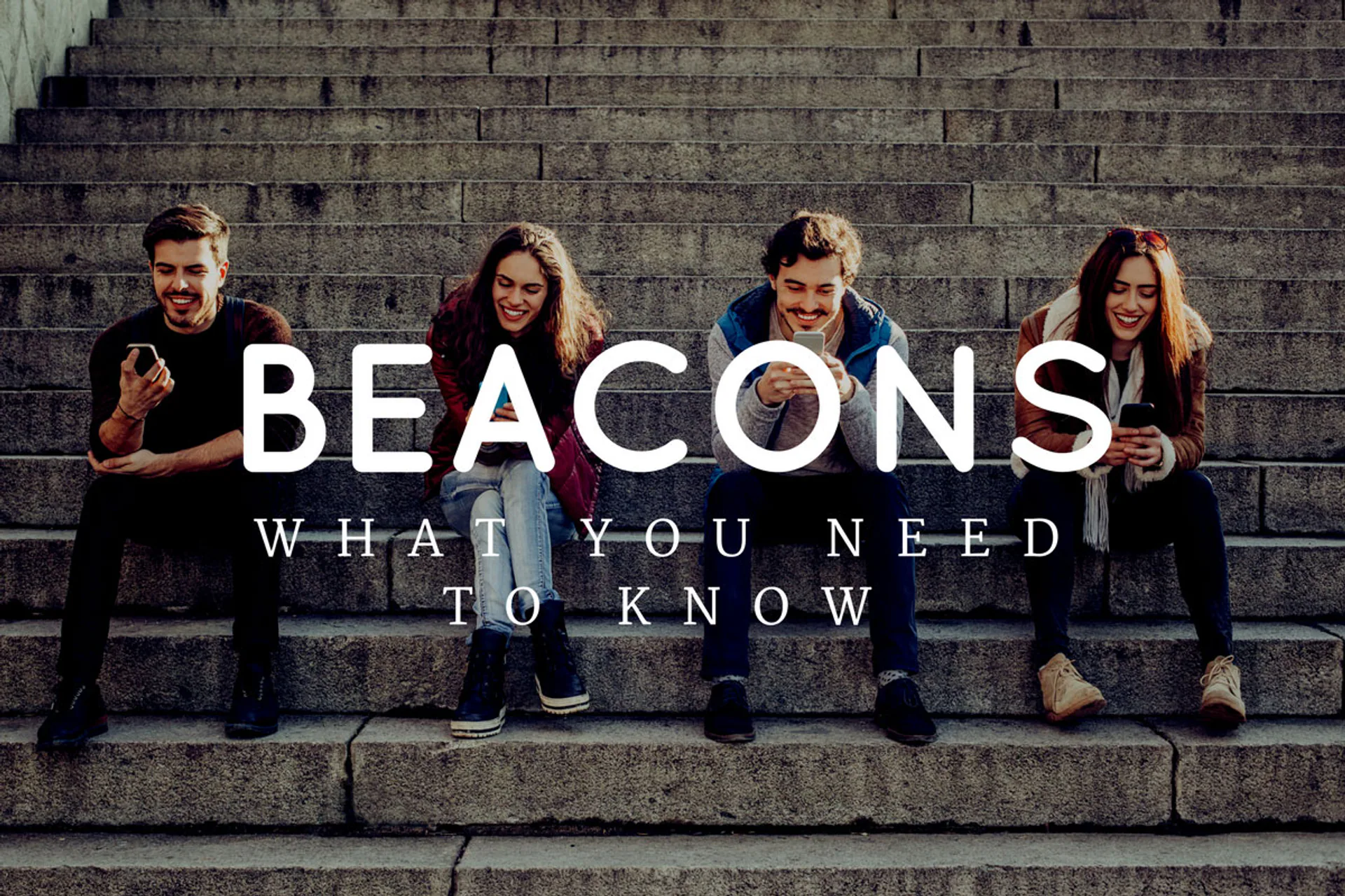 People sitting beneath a Bluetooth beacons title