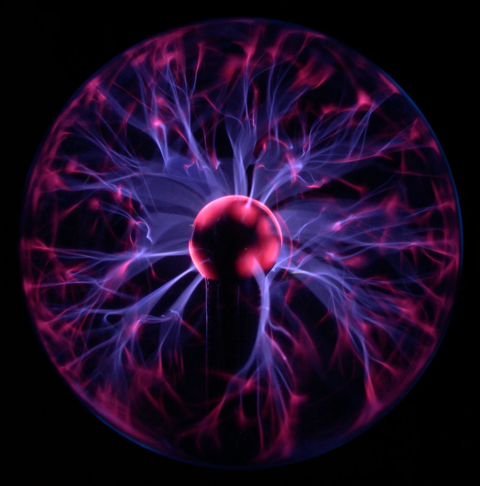 Purple electrical filaments glowing inside a plasma globe