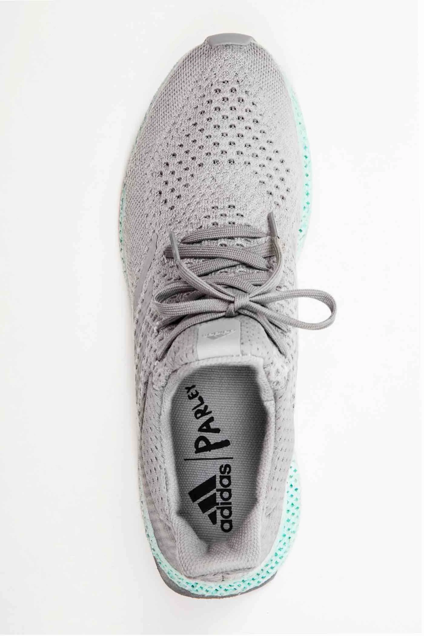 Top view of a grey Adidas shoe with a turquoise lattice midsole