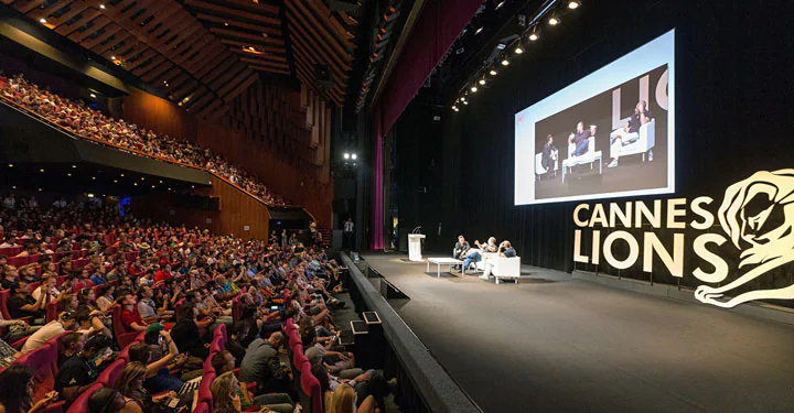 Audience watching a panel on the Cannes Lions stage