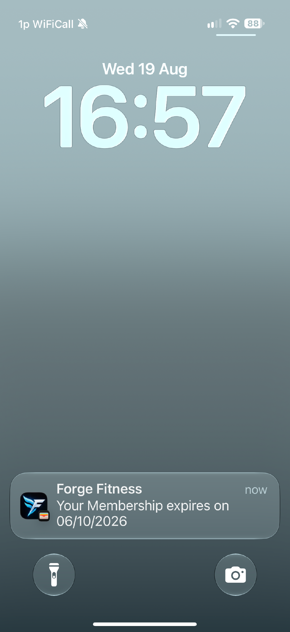 A lock screen notification showing a Forge Fitness membership update.